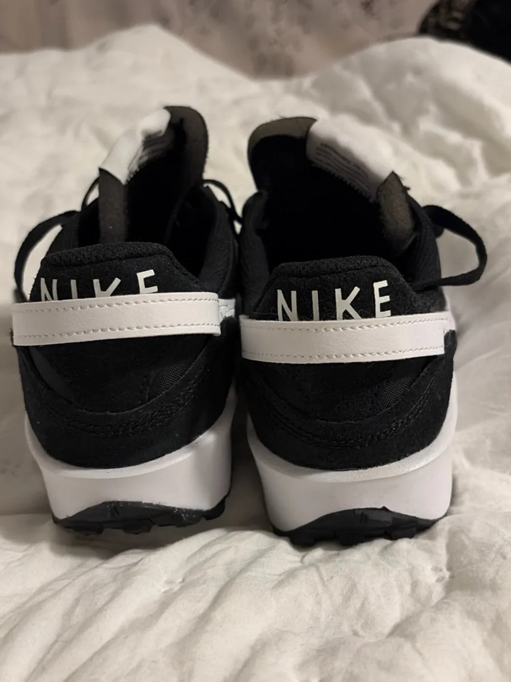 Nike Black Sneakers with White Swoosh and Orange Logo